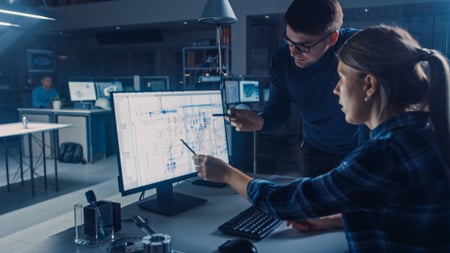 Cybersecurity professionals looking at screen