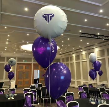 A picture of branded balloons and a goody bags on chairs for team members on Titania Team Day
