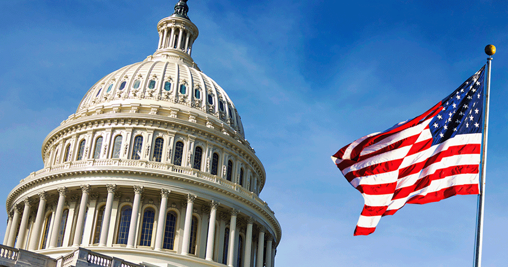 Close up of American flag next to Capital Building in Washington DC.