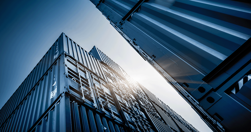 Close up of logistics building, towering in front of bright sun.