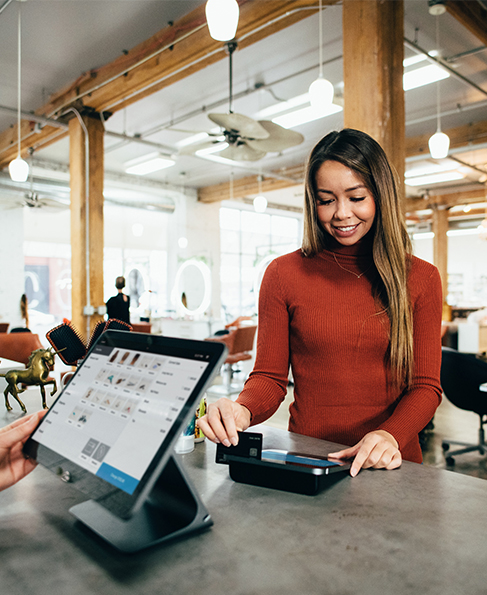 A woman completing a purchase in a store A woman completing a purchase in a store