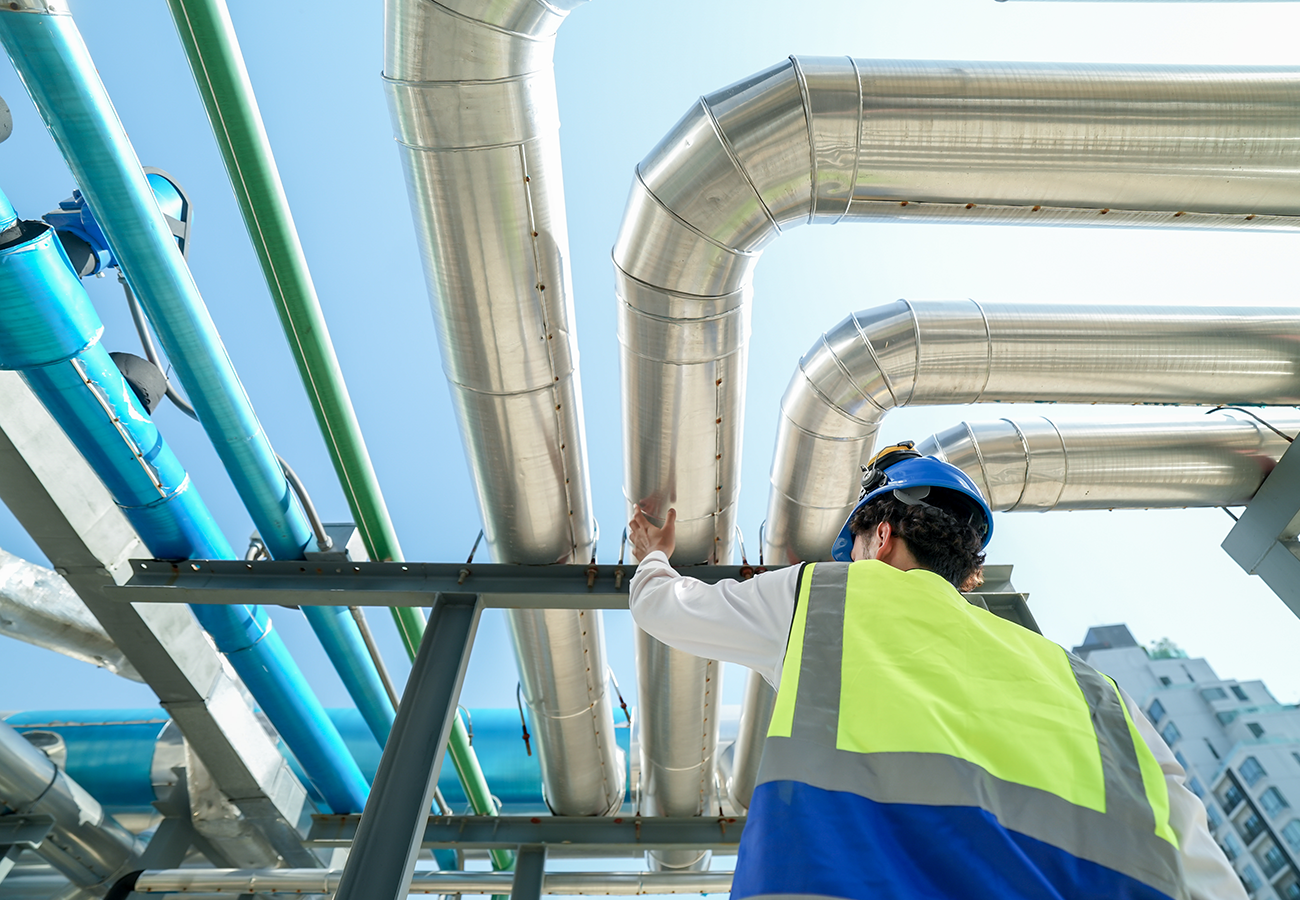 Engineer looking at pipeline on construction site